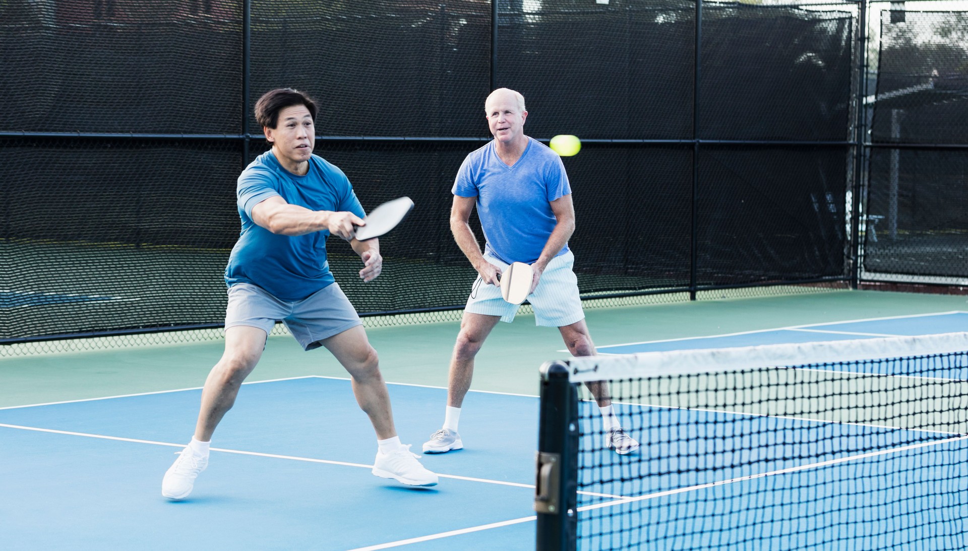 Men's doubles team playing pickleball